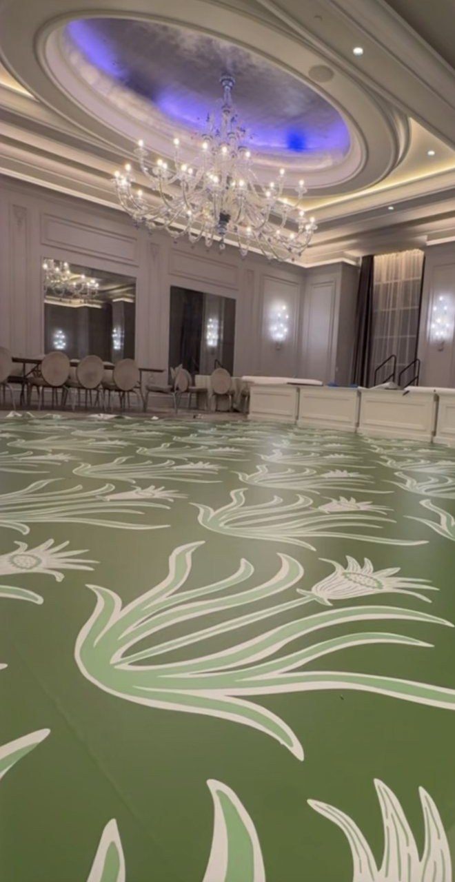 Matte green dance floor wrap with a white and sage botanical print at The Grand Bohemian Hotel Charlotte